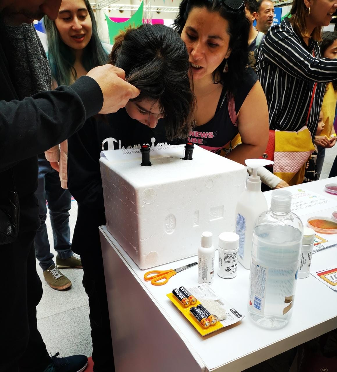 A young woman gazes into a microscope at the festival